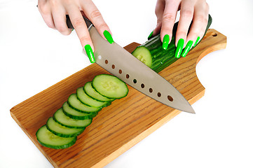 Image showing Cutting cucumbers