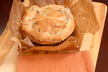 Image showing Paperbag apple pie on cutting board