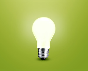 Image showing glowing Light bulb idea on green background