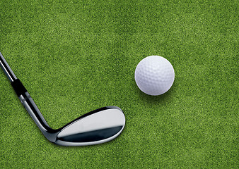 Image showing Golf ball and putter on green grass 