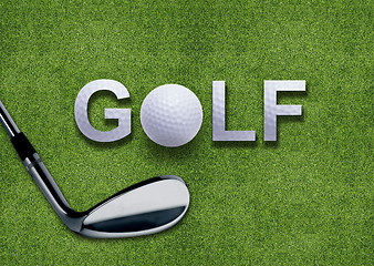 Image showing Golf ball and putter on green grass 