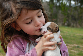 Image showing little girl and puppy