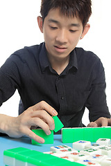 Image showing Chinese man play Mahjong, traditional China gamble. 