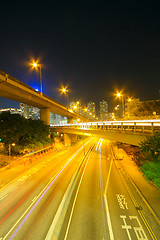 Image showing Traffic at night with traces of lights left by the cars on a hig