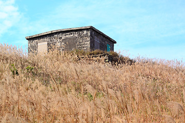 Image showing old stone house with grass on the mountain 