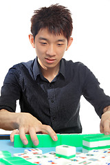 Image showing Chinese man play Mahjong, traditional China gamble. 