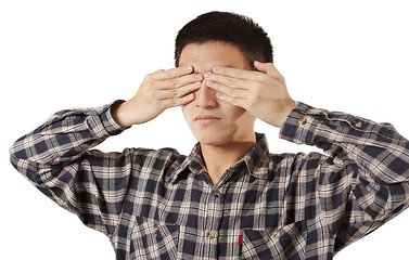 Image showing Portrait of a young man covering his eyes with hands 