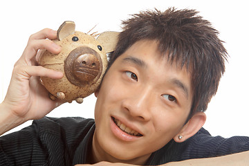 Image showing asia man with piggy bank 