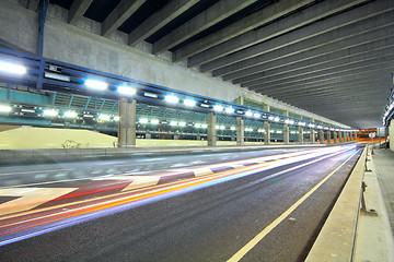 Image showing Traffic at night with traces of lights left by the cars on a hig