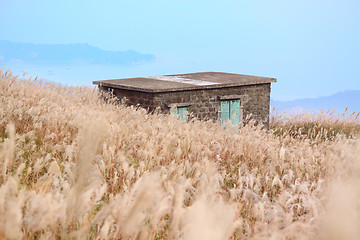 Image showing old stone house with grass on the mountain 