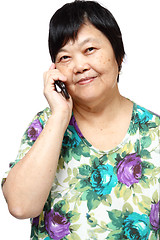 Image showing Old senior woman using the internet with her mobile phone 