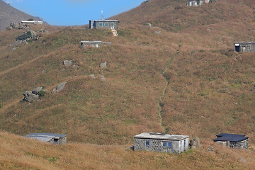 Image showing old stone house with grass on the mountain 