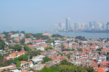 Image showing Aerial image of a modern city by a river 