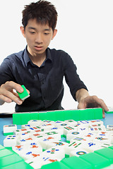 Image showing Chinese man play Mahjong, traditional China gamble. 