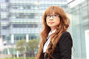 Image showing young business woman and an office background