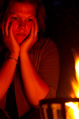 Image showing Female is staring into the fire