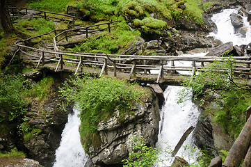 Image showing Wooden bridge over Saent waterfalls in the Italian mountains