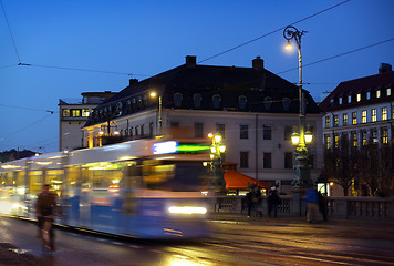 Image showing 	Gothenburg at night. Some trams and people in motion