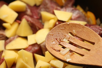 Image showing goulash cooking with a spoon