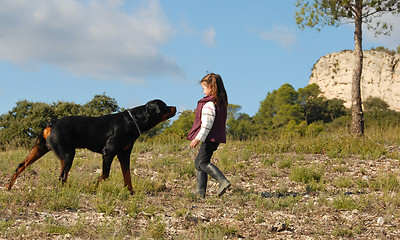 Image showing little girl and rottweiler