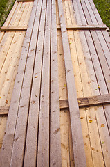 Image showing Long wooden planks loaded in a bunch. 