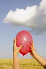 Image showing Hand holding red balloon.