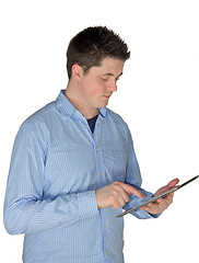 Image showing Young man touching a tablet