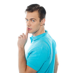 Image showing Side view of smart handsome guy gesturing silence