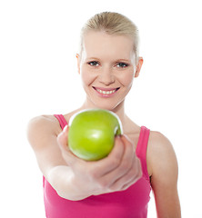 Image showing Healthy teenager offering green apple to you