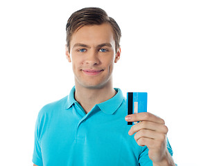 Image showing Close-up of handsome guy holding a credit card