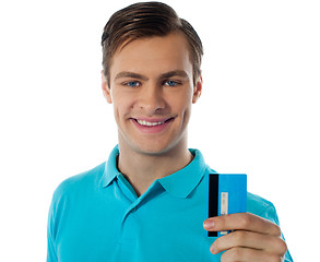 Image showing Close-up portrait of fashionable guy holding debit card