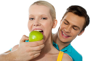 Image showing Love couple. Girlfriend eating an apple