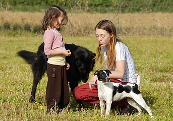 Image showing sisters and dogs