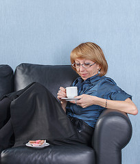 Image showing woman drink coffee on couch