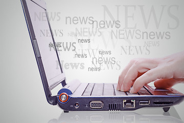 Image showing Image of hand on the laptop keyboard with the word news out of t