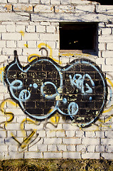 Image showing Graffiti paint on abandoned building brick wall 