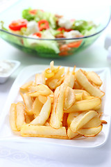 Image showing Baked potatoes with dip and vegetable salad