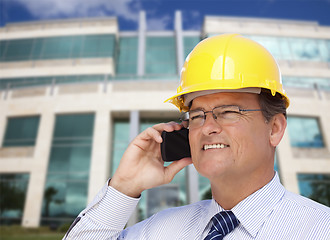 Image showing Contractor in Hardhat Talks on Phone In Front of Building