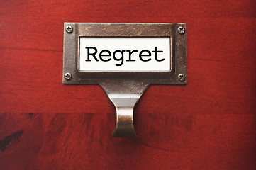 Image showing Lustrous Wooden Cabinet with Regret File Label