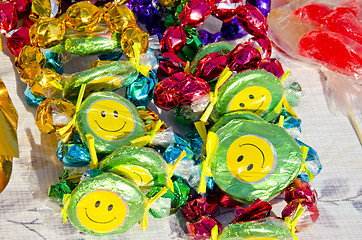 Image showing Colorful candies smiles sold street fair sunlight 