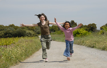 Image showing running sisters