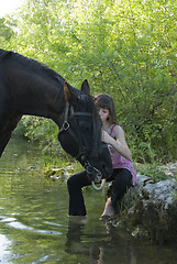 Image showing child and horse in river