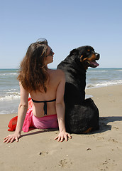 Image showing woman on the beach with her rottweiler