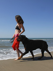 Image showing woman and rottweiler on the beach