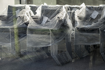 Image showing Stacks of wrapped office chairs