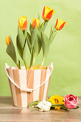 Image showing It is red yellow tulips in a bucket