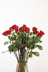 Image showing bouquet of red roses in a vase on white background