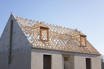 Image showing house under construction with the roof structure of wood