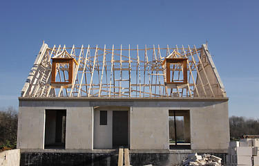 Image showing house under construction with the roof structure of wood