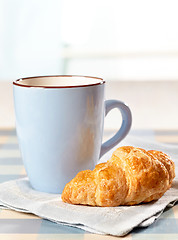 Image showing croissant and tea cup